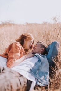 Couple kissing in a field